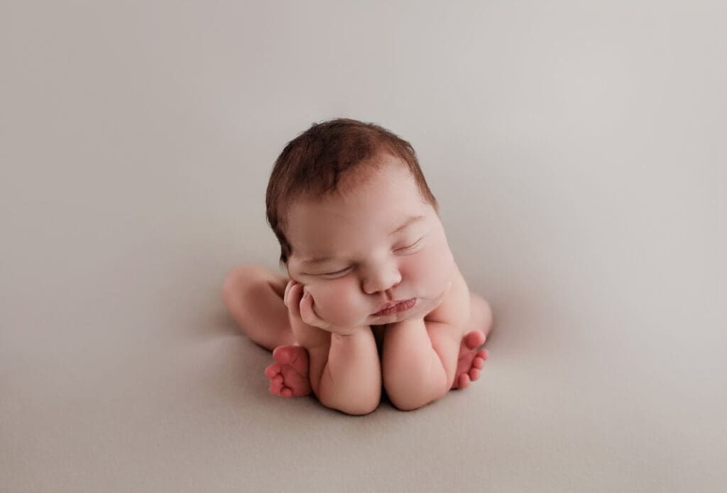 sleeping baby posed through a safe composite