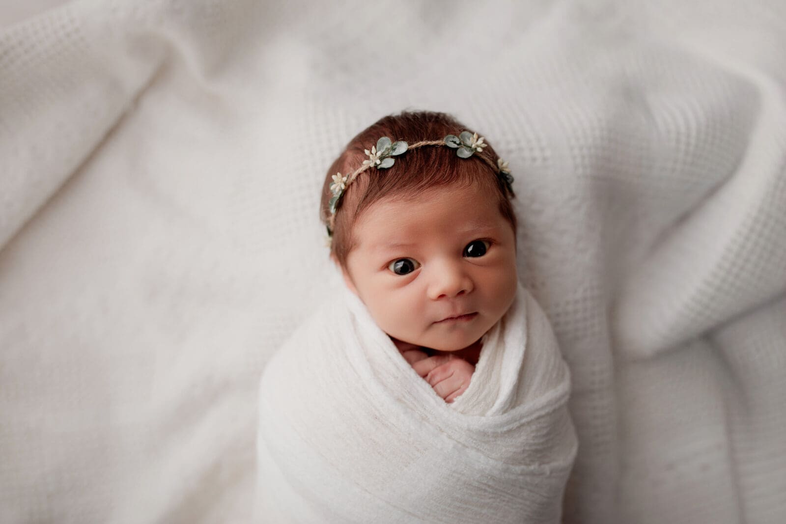 wide awake baby swaddled and cozy