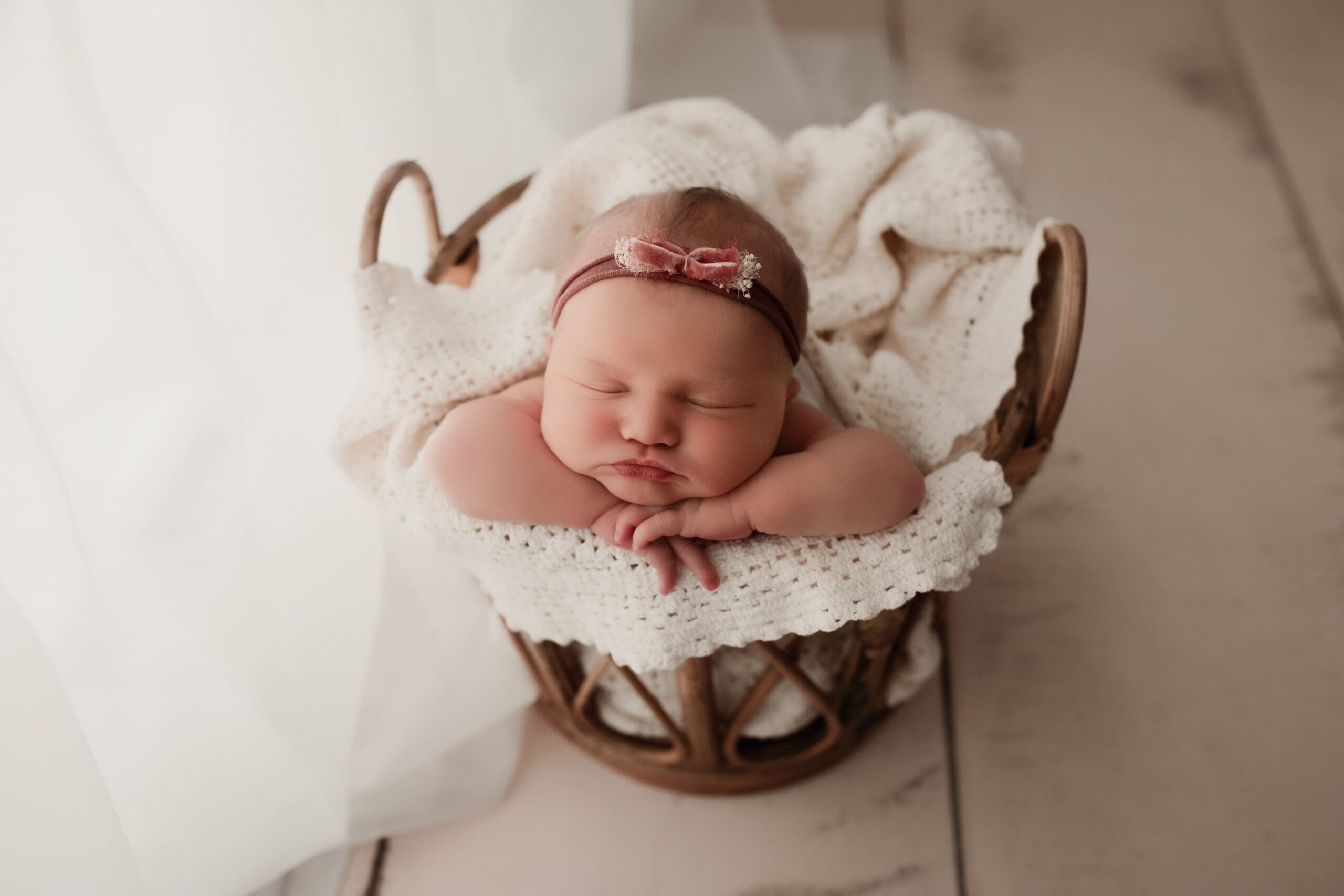 Sleeping newborn in boho basket