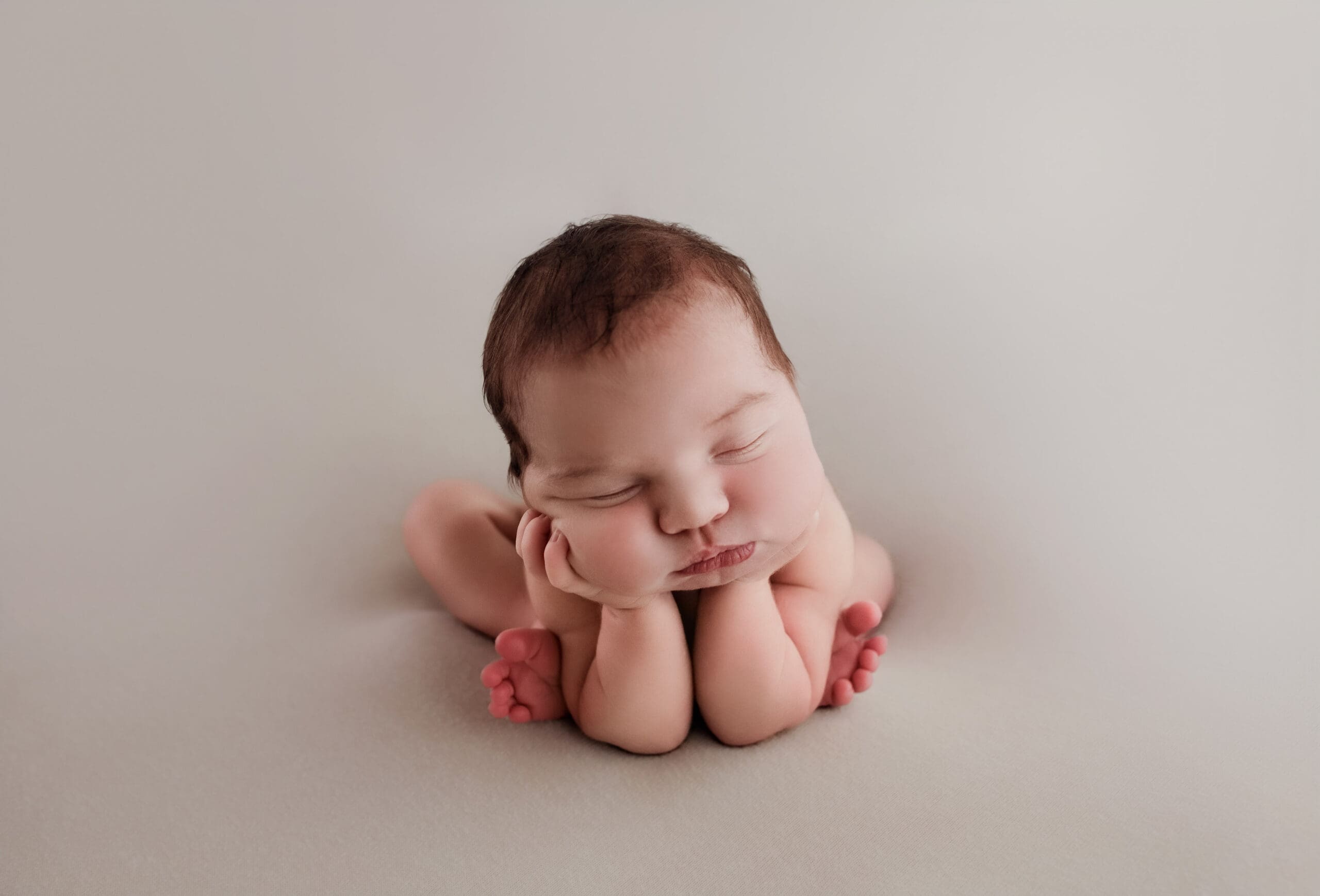 sleeping baby posed through a safe composite